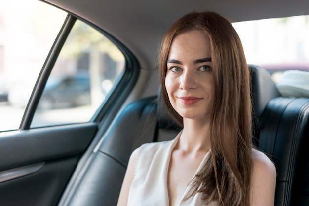 Business woman posing inside a car