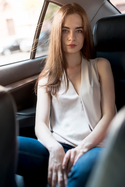 Business woman posing inside a car