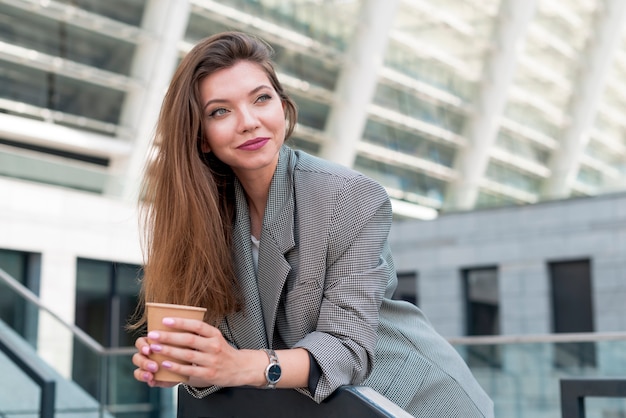 Free photo business woman posing in the street