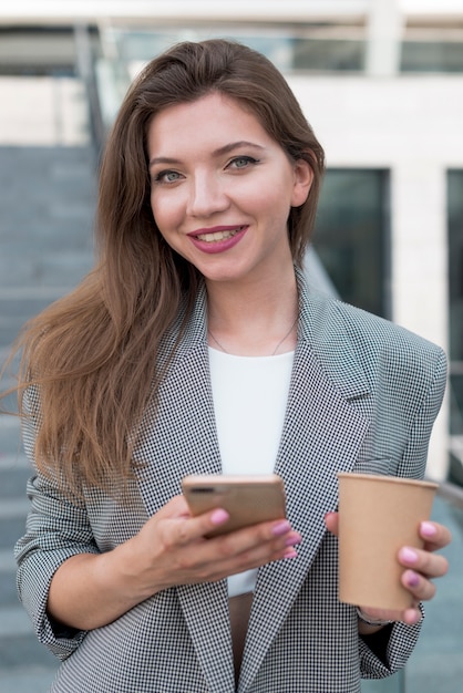 Free photo business woman posing in the street