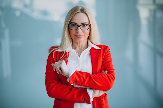 Business woman in red jacket isolated in office