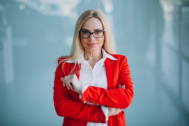 Business woman in red jacket isolated in office