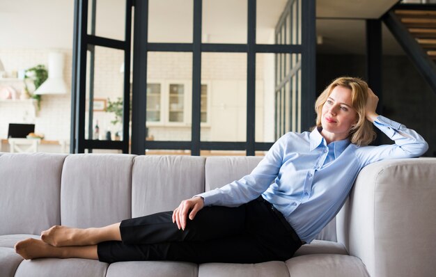 Business woman resting on couch 