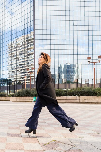 Business woman running on street