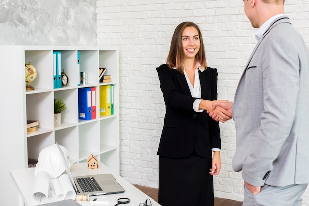 Business woman shaking hand with a man