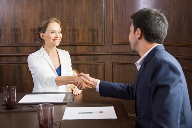 Business woman shaking hands with a man