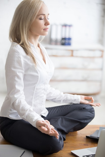 Business woman sitting in padmasana pose