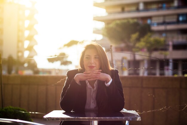 Business woman sitting at table outside