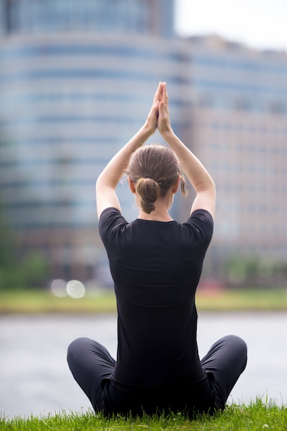 Free photo business woman sitting in yoga pose