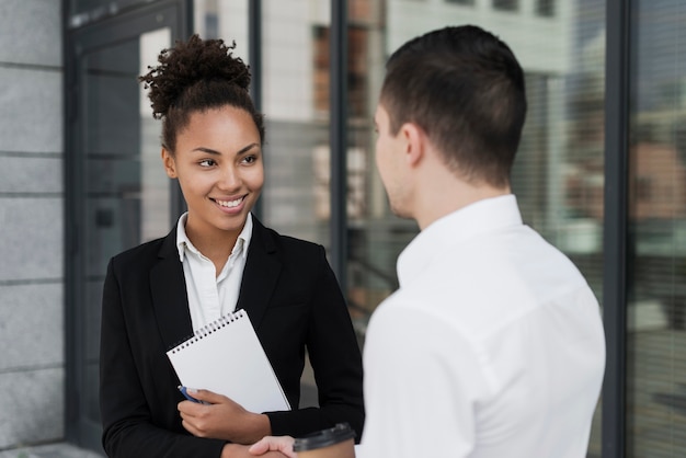 Business woman smiling at man