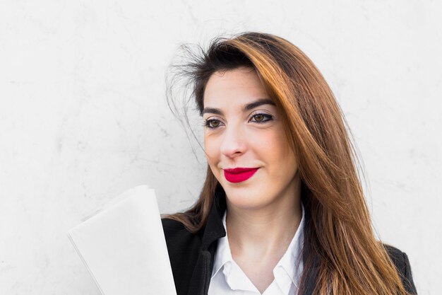 Business woman standing with papers 