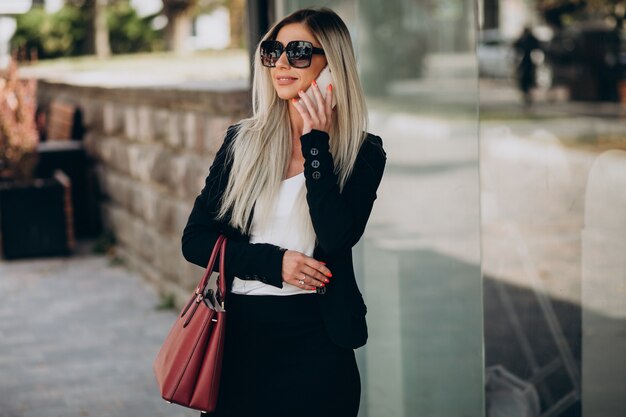 Business woman talking on the phone in the street