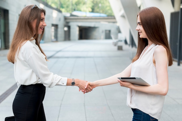 Business woman together at the street