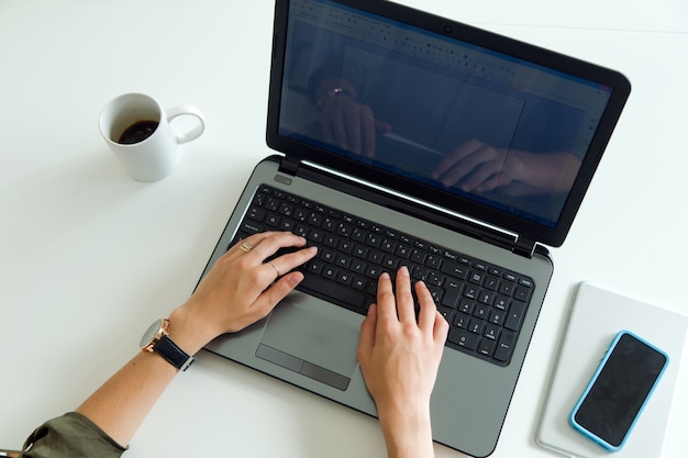 Business woman using her laptop in the office.