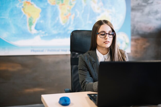 Business woman using laptop at table