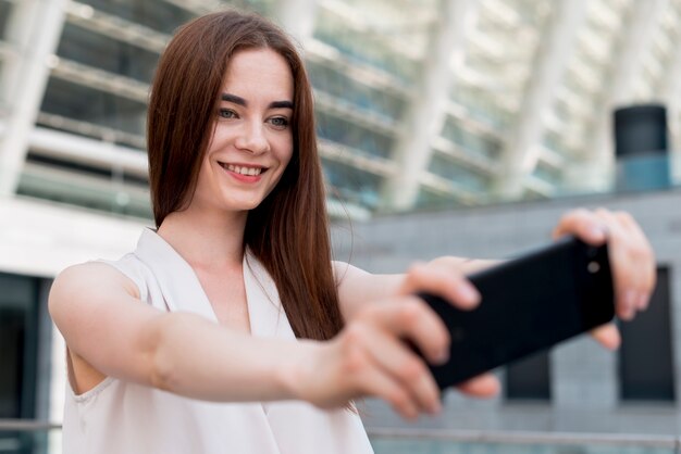 Business woman using smartphone in the street