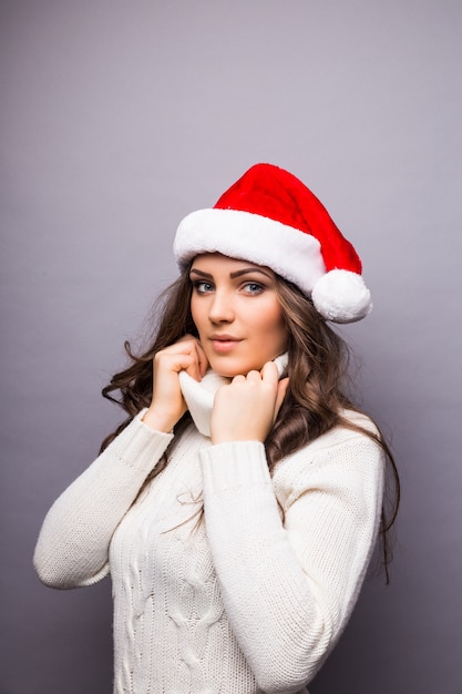 Business woman wearing Santa red hat. Smiling santa girl isolated portrait.