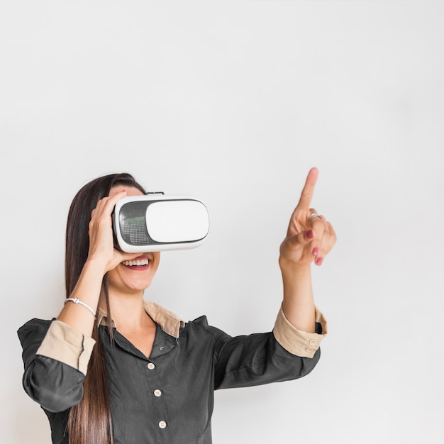 Business woman wearing vr glasses and pointing out