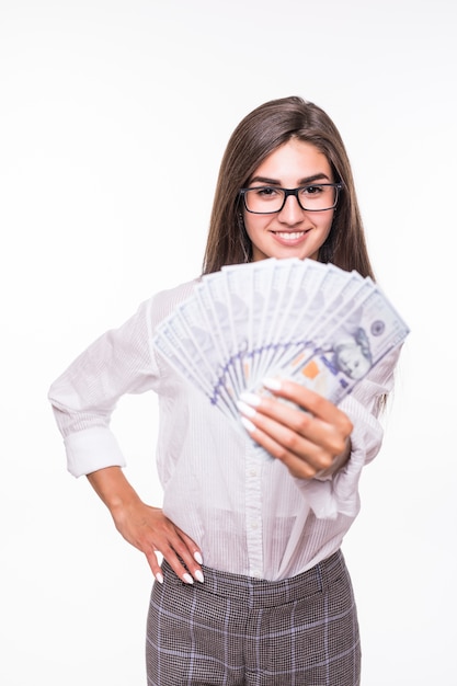 Business woman with brown hair in casual clothes hold lots of dollar banknotes over white