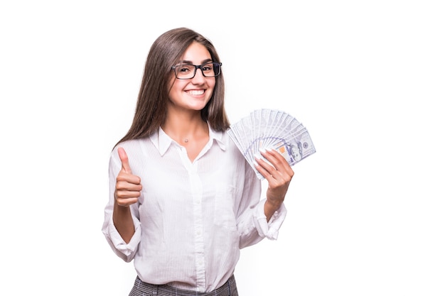 Business woman with long brown hair in casual clothes hold lots of dollar banknotes over white