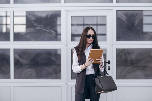 Business woman with an orange tablet in hands