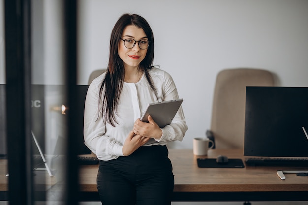 Business woman with tablet standing at the office