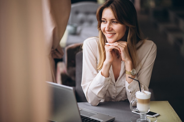 Business woman working on computer in a cafe