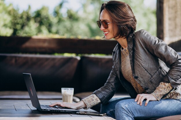 Business woman working on laptop out of home