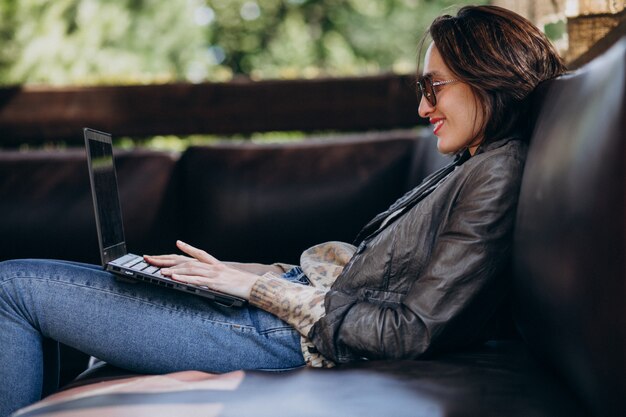 Business woman working on laptop out of home