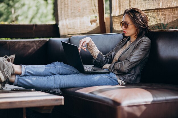 Business woman working on laptop out of home