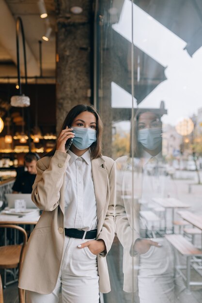 Business woman working in quarantine speak by the phone