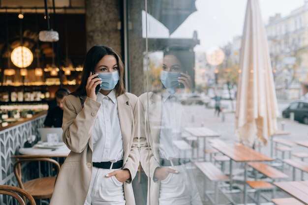 Business woman working in quarantine speak by the phone