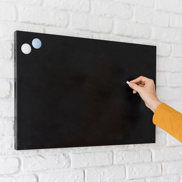 Business woman writing on chalkboard