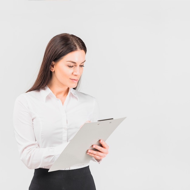 Business woman writing on clipboard