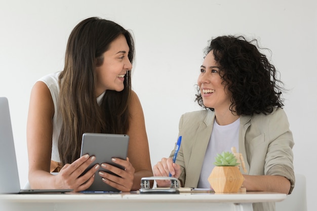 Business women smiling at each other