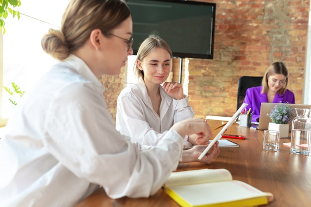 Business young caucasian woman in modern office with team