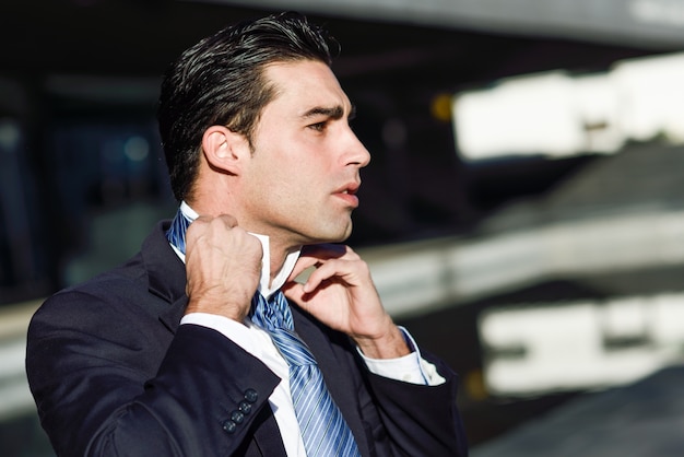  businessman adjusting his shirt collar