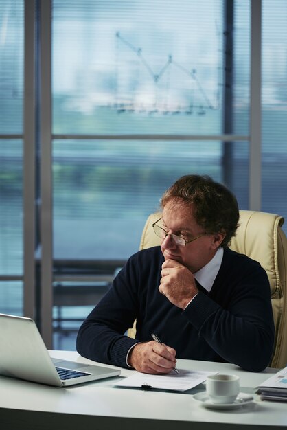 Businessman analyzing financial information in his office