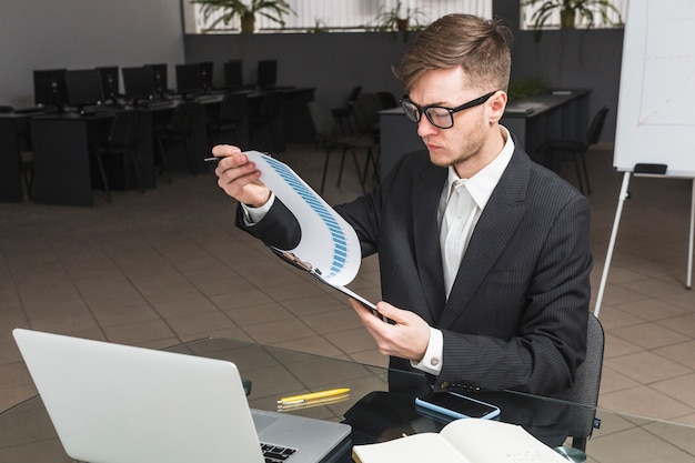 Businessman analyzing graph in office