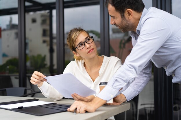 Businessman asking expert to check document