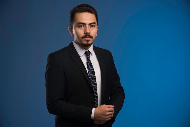 Free Photo businessman in black suit with a tie posing. 