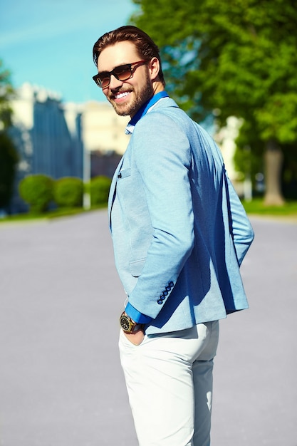 Businessman in blue suit wearing sunglasses in the street