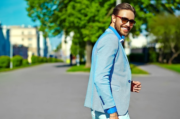 Businessman in blue suit wearing sunglasses in the street