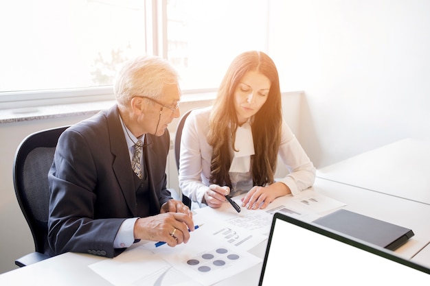 Businessman and businesswoman discussing the business plan with chart