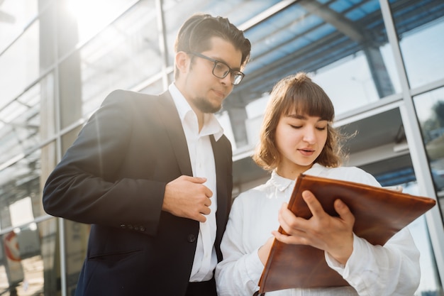 Businessman and businesswoman look at important papers