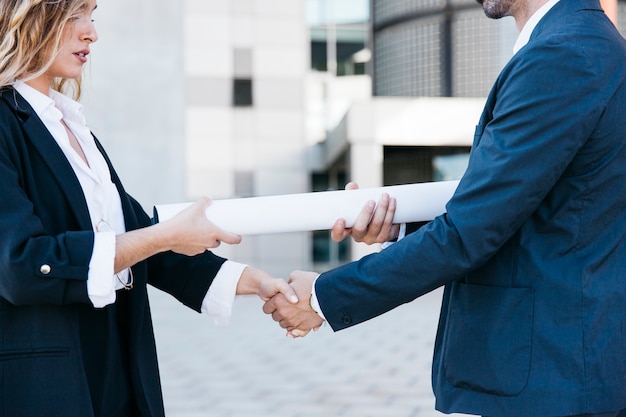 Businessman and businesswoman shaking hands scene