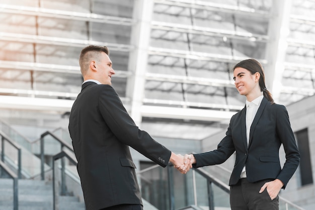 Businessman and businesswoman shaking hands