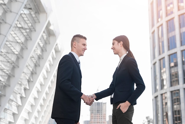 Businessman and businesswoman shaking hands