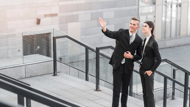 Businessman and businesswoman talking to each other