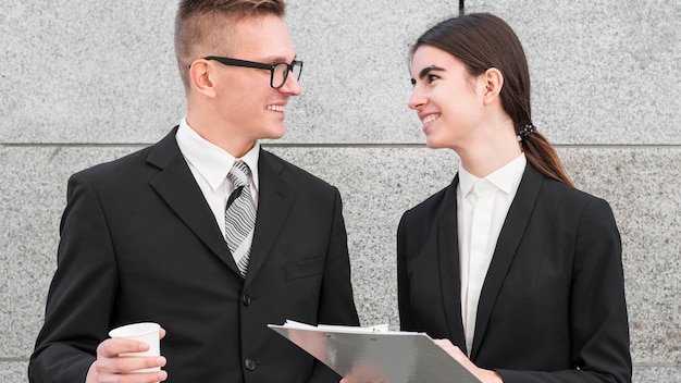 Businessman and businesswoman talking to each other